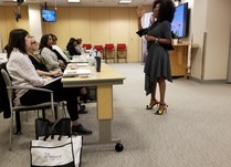 Woman talking to conference attendees 
