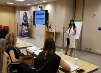 Woman talking to conference attendees 
