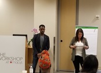 Man and woman presenting in a room of conference attendees 