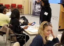 Woman talking to conference attendees 