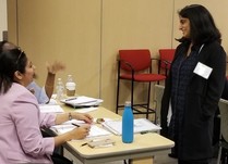 Woman talking to conference attendees 