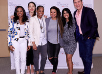Conference attendees in front of a "The Workshop at Macy's" backdrop