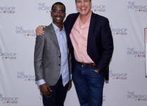 Conference attendees in front of a "The Workshop at Macy's" backdrop