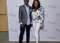 Conference attendees in front of a "The Workshop at Macy's" backdrop
