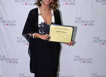 Mare Cheia with a Certificate of Completion in front of a "The Workshop at Macy's" backdrop