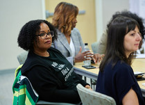 Conference attendees engaged in conversation around a table