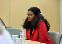 Woman engaged in conversation around a table