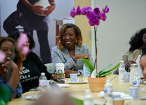 Conference attendees engaged in conversation around a table