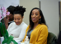 Conference attendees engaged in conversation around a table