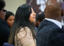 Conference attendees engaged in conversation around a table