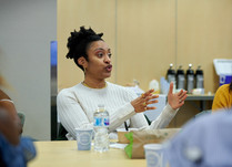 Woman engaged in conversation around a table