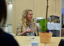 Woman engaged in conversation around a table