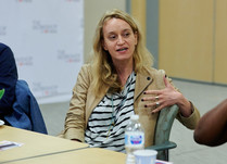 Woman engaged in conversation around a table
