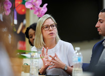 A woman addressing other attendees