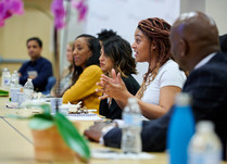 A woman addressing other attendees