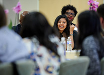 A woman addressing other attendees