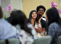 A woman addressing other attendees