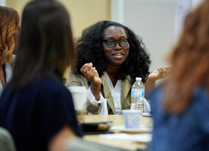 A woman talking to other attendees