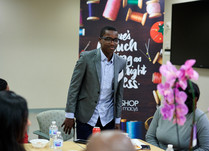 A man stands from his chair