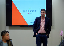 A man presents to conference attendees