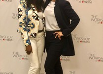 Two women posing in front of The Workshop at Macys banner