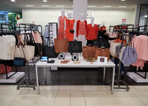 Product table showing black and brown bags with a sign that says Jo