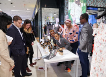Product representatives and attendees watching a laptop