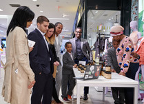 Product representative hugging a young boy while talking with interested attendees