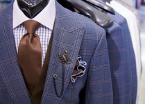 Blue and brown plaid suit coat with matching shirt, tie and scorpion pin
