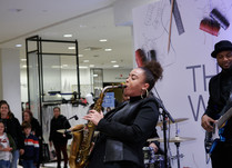 Close up of saxophone player in band playing at conference