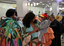 Two women, one holding a child on their hip