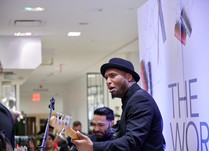 Close up of bass player in band playing at conference