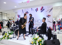 Four person band playing on a stage at conference