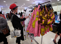 Woman looking at a clothing rack