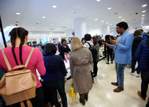 Attendees looking at a product table