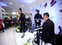 Four person band playing on a stage at conference