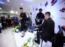 Four person band playing on a stage at conference