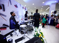 Four person band playing on a stage at conference