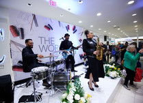 Four person band playing on a stage at conference