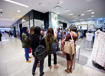 Conference attendees gathered around looking at products at a table