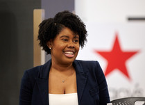 Headshot of woman with Macy's logo in the background