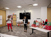 Two women representing Black Paper Party speak to workshop attendees