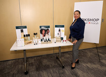 Attendee standing next to Absolute Joi product table