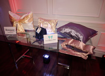 Lux Pillows Plus display table with variety of pillow products