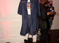 Mannequin with denim-like long jacket and shorts, black boots and graphic t-shirt