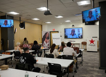 Workshop room with a video presenter on 3 screens