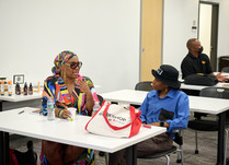 Attendees seated a table talking with each other