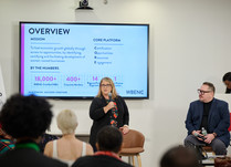 A seated panel of three presents to workshop attendees