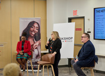 A seated panel of three presents to workshop attendees