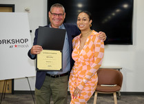 A man presenting a woman with a Ben Oni Certificate of Completion